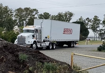White tractor with an Arbiso dry van trailer