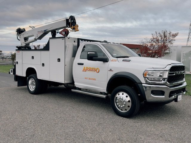 White Arbiso service truck with a crane and utility body